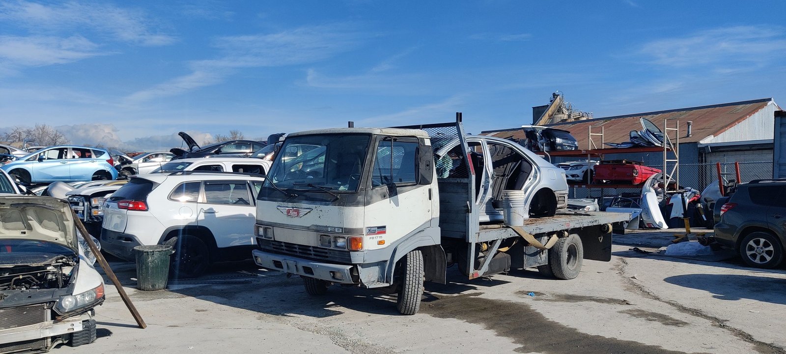 Scrap cars piled in Cash Car BC yard ready for eco-friendly recycling and disposal